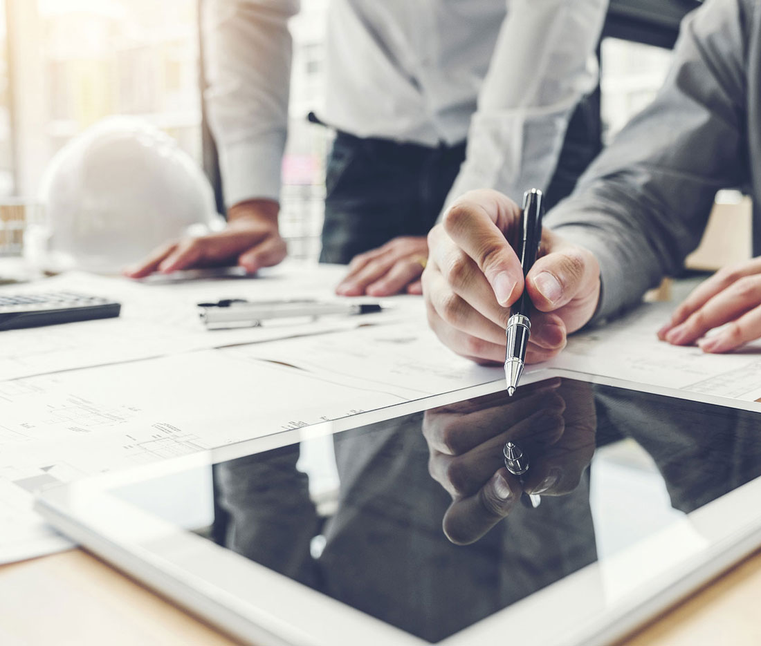 Engineer reviews plans on an digital notebook